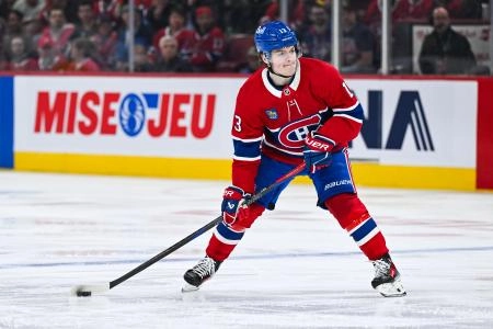 Apr 16, 2025; Montreal, Quebec, CAN; Montreal Canadiens right wing Cole Caufield (13) plays the puck against the Carolina Hurricanes in the third period at Bell Centre. Mandatory Credit: David Kirouac-Imagn Images