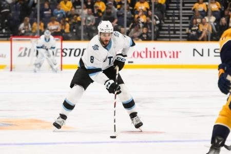Apr 14, 2025; Nashville, Tennessee, USA; Utah Hockey Club center Nick Schmaltz (8) skates with the puck against the Nashville Predators during the second period at Bridgestone Arena. Mandatory Credit: Steve Roberts-Imagn Images