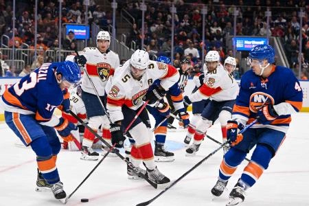 Oct 26, 2024; Elmont, New York, USA; Florida Panthers defenseman Aaron Ekblad (5) battles for a loose puck with New York Islanders center Mathew Barzal (13) and New York Islanders center Jean-Gabriel Pageau (44) during the second period at UBS Arena. Mandatory Credit: Dennis Schneidler-Imagn Images Oct 26, 2024; Elmont, New York, USA; Florida Panthers defenseman Aaron Ekblad (5) battles for a loose puck with New York Islanders center Mathew Barzal (13) and New York Islanders center Jean-Gabriel Pageau (44) during the second period at UBS Arena. Mandatory Credit: Dennis Schneidler-Imagn Images