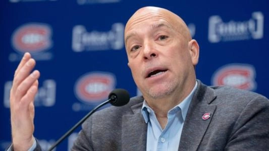 Montreal Canadiens GM Kent Hughes speaks to reporters with his hand out