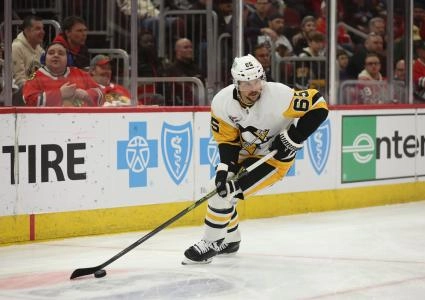 Apr 6, 2025; Chicago, Illinois, USA; Pittsburgh Penguins defenseman Erik Karlsson (65) clears the puck during the first period against the Chicago Blackhawks at United Center. Mandatory Credit: Talia Sprague-Imagn Images