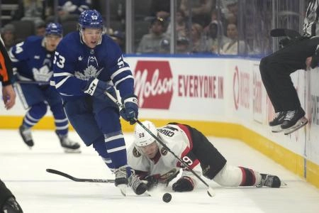 Sep 25, 2023; Toronto, Ontario, CAN; Toronto Maple Leafs forward Easton Cowan (53) carries the puck past Ottawa Senators forward Angus Crookshank (59) during the third period at Scotiabank Arena. Mandatory Credit: John E. Sokolowski-Imagn Images