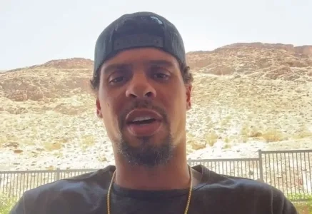 Ryan Reaves speaks to the media in front of a hill