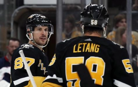 Mar 28, 2024; Pittsburgh, Pennsylvania, USA; Pittsburgh Penguins center Sidney Crosby (87) talks with defenseman Kris Letang (58) before a face-off against the Columbus Blue Jackets during the third period at PPG Paints Arena. The Penguins won 3-2. Mandatory Credit: Charles LeClaire-Imagn Images