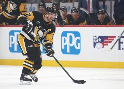 Mar 21, 2025; Pittsburgh, Pennsylvania, USA; Pittsburgh Penguins center Sidney Crosby (87) moves the puck against the Columbus Blue Jackets during the first period at PPG Paints Arena. Mandatory Credit: Charles LeClaire-Imagn Images