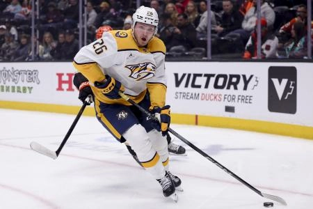 Mar 14, 2025; Anaheim, California, USA; Nashville Predators left wing Kieffer Bellows (26) moves the puck against the Anaheim Ducks during the first period at Honda Center. Mandatory Credit: Ryan Sun-Imagn Images