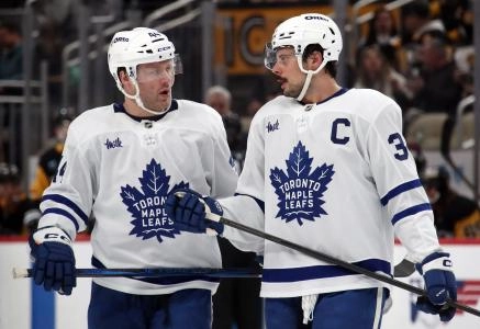 Dec 7, 2024; Pittsburgh, Pennsylvania, USA; Toronto Maple Leafs defenseman Morgan Rielly (44) and center Auston Matthews (34) talk before a face-off against the Pittsburgh Penguins during the second period at PPG Paints Arena. Mandatory Credit: Charles LeClaire-Imagn Images