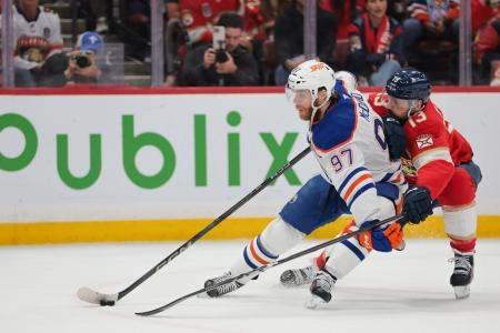 Jun 17, 2025; Sunrise, Florida, USA; Edmonton Oilers center Connor McDavid (97) controls the puck defended by Florida Panthers center Sam Reinhart (13) during the first period in game six of the 2025 Stanley Cup Final at Amerant Bank Arena. Mandatory Credit: Sam Navarro-Imagn Images
