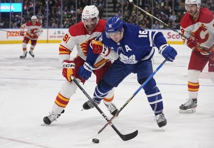 Dec 10, 2022; Toronto, Ontario, CAN; Toronto Maple Leafs forward Mitchell Marner (16) battles with Calgary Flames forward Nazem Kadri (91) for control of the puck during the third period at Scotiabank Arena Dec 10, 2022; Toronto, Ontario, CAN; Toronto Maple Leafs forward Mitchell Marner (16) battles with Calgary Flames forward Nazem Kadri (91) for control of the puck during the third period at Scotiabank Arena