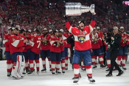 Jun 17, 2025; Sunrise, Florida, USA; Florida Panthers left wing Matthew Tkachuk (19) hoist the Stanley Cup after game six of the 2025 Stanley Cup Final against the Edmonton Oilers at Amerant Bank Arena. Mandatory Credit: Jim Rassol-Imagn Images Jun 17, 2025; Sunrise, Florida, USA; Florida Panthers left wing Matthew Tkachuk (19) hoist the Stanley Cup after game six of the 2025 Stanley Cup Final against the Edmonton Oilers at Amerant Bank Arena. Mandatory Credit: Jim Rassol-Imagn Images