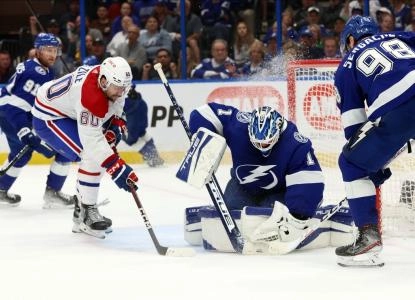 Mar 18, 2023; Tampa, Florida, USA; Tampa Bay Lightning goaltender Brian Elliott (1) saves a shot by Montreal Canadiens right wing Alex Belzile (60) during the second period at Amalie Arena. Mandatory Credit: Kim Klement-Imagn Images