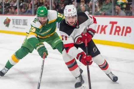 Mar 29, 2025; Saint Paul, Minnesota, USA; Minnesota Wild center Yakov Trenin (13) stick checks New Jersey Devils defenseman Simon Nemec (17) in the second period at Xcel Energy Center. Mandatory Credit: Matt Blewett-Imagn Images