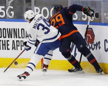 Toronto Maple Leafs forward Auston Matthews and Edmonton Oilers forward Leon Draisaitl getting into a board battle. Toronto Maple Leafs forward Auston Matthews and Edmonton Oilers forward Leon Draisaitl getting into a board battle.