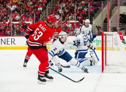 Apr 13, 2025; Raleigh, North Carolina, USA; Toronto Maple Leafs defenseman Simon Benoit (2) stops the scoring attempt by Carolina Hurricanes right wing Jackson Blake (53) during the third period at Lenovo Center. Mandatory Credit: James Guillory-Imagn Images Apr 13, 2025; Raleigh, North Carolina, USA; Toronto Maple Leafs defenseman Simon Benoit (2) stops the scoring attempt by Carolina Hurricanes right wing Jackson Blake (53) during the third period at Lenovo Center. Mandatory Credit: James Guillory-Imagn Images