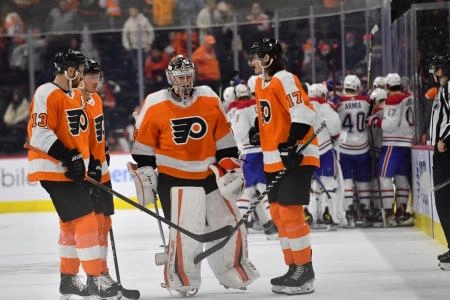 Mar 13, 2022; Philadelphia, Pennsylvania, USA; Philadelphia Flyers center Kevin Hayes (13), goaltender Carter Hart (79) and center Zack MacEwen (17) skate off the ice during overtime loss against the Montreal Canadiens at Wells Fargo Center. Mandatory Credit: Eric Hartline-Imagn Images