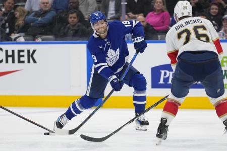 Toronto Maple Leafs forward Calle Jarnkrok attempting a shot on goal against the Florida Panthers. Toronto Maple Leafs forward Calle Jarnkrok attempting a shot on goal against the Florida Panthers.