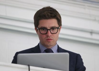 Sep 18, 2018; Lucan, Ontario, CAN; Toronto Maple Leafs general manager Kyle Dubas on his laptop before the start of their game against the Ottawa Senators at Lucan Community Memorial Centre. The Maple Leafs beat the Senators 4-1. Mandatory Credit: Tom Szczerbowski-Imagn Images