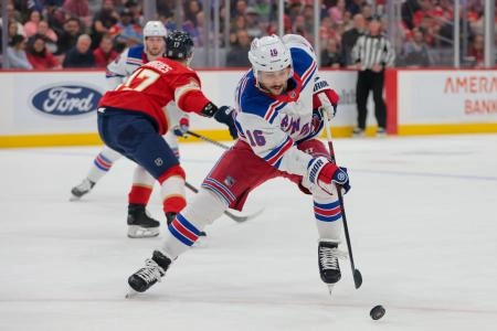 Apr 14, 2025; Sunrise, Florida, USA; New York Rangers center Vincent Trocheck (16) moves the puck against the Florida Panthers during the first period at Amerant Bank Arena. Mandatory Credit: Sam Navarro-Imagn Images