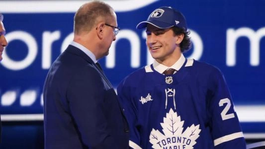 Toronto Maple Leafs' Ben Danford shakes GM Brad Treliving's hand at the draft