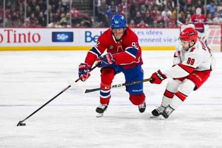 Apr 16, 2025; Montreal, Quebec, CAN; Carolina Hurricanes defenseman Domenick Fensore (89) defends against Montreal Canadiens right wing Patrik Laine (92) in the first period at Bell Centre.