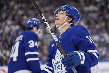 May 18, 2025; Toronto, Ontario, CAN; Toronto Maple Leafs forward Mitch Marner (16) looks up at the scoreboard as Toronto Maple Leafs forward Auston Matthews (34) skates to the bench during the third period of game seven of the second round of the 2025 Stanley Cup Playoffs against the Florida Panthers at Scotiabank Arena. Mandatory Credit: John E. Sokolowski-Imagn Images