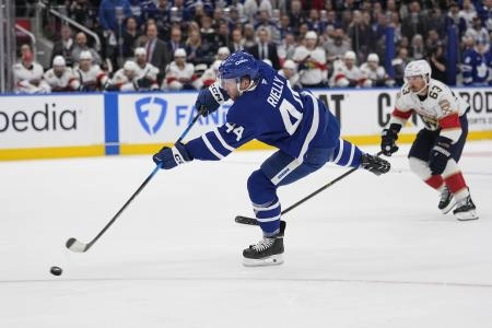 May 5, 2025; Toronto, Ontario, CAN; Toronto Maple Leafs defenseman Morgan Rielly (44) scores as Florida Panthers forward Brad Marchand (63) trails the play during the first period of the second round of the 2025 Stanley Cup Playoffs at Scotiabank Arena. Mandatory Credit: John E. Sokolowski-Imagn Images