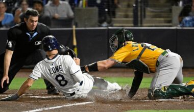 Tampa Bay Rays' Brandon Lowe (8) is tagged out at home by Athletics catcher Shea Langeliers, right, during the eighth inning of a baseball game Monday, June 30, 2025, in Tampa, Fla. (AP Photo/Jason Behnken)