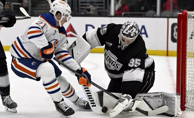 Los Angeles Kings goaltender Darcy Kuemper (35) stops a shot by Edmonton Oilers center Trent Frederic (21) during the first period of an NHL hockey game in Los Angeles, Saturday, April 5, 2025. (AP Photo/Alex Gallardo)