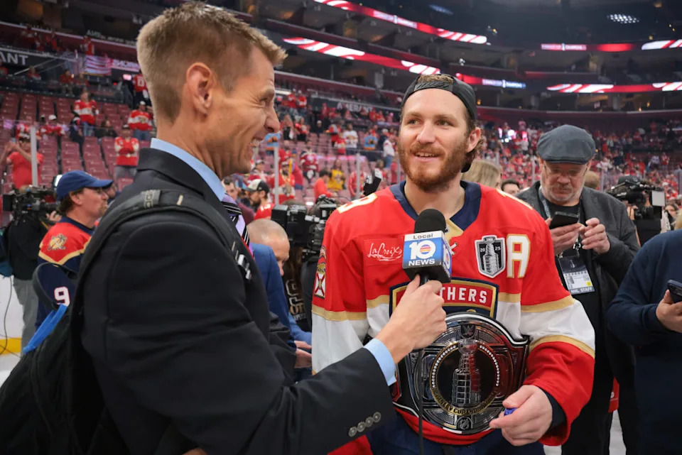 Panthers left wing Matthew Tkachuk (19) is interviewed while wearing the belt after winning game six of the 2025 Stanley Cup Final.© Sam Navarro-Imagn Images
