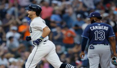 Detroit Tigers' Zach McKinstry, left, rounds the bases past Tampa Bay Rays third baseman Junior Caminero (13) after hitting a home run during the seventh inning of a baseball game Monday, July 7, 2025, in Detroit. (AP Photo/Duane Burleson)
