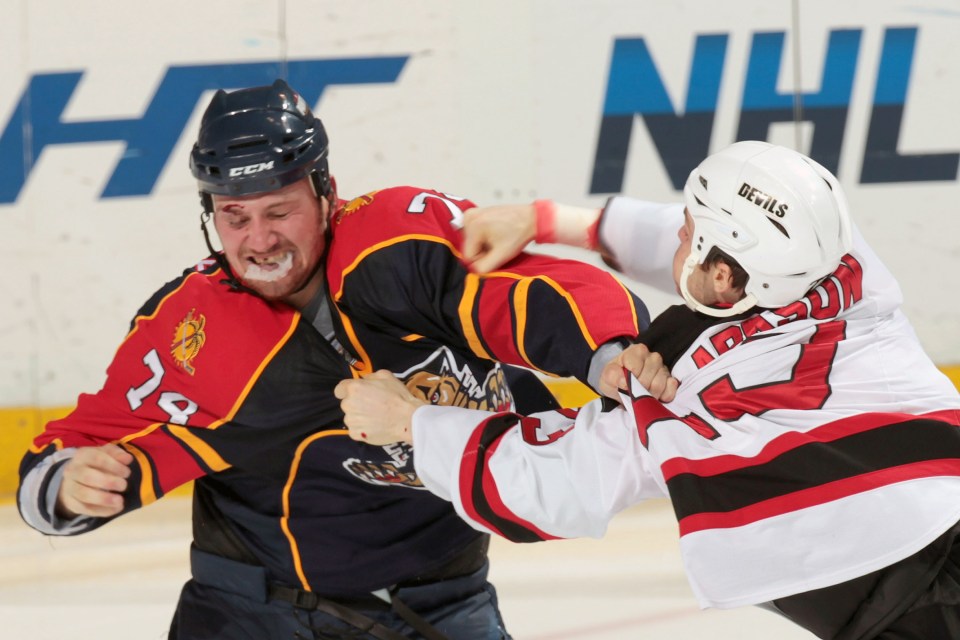 Florida Panthers player #74 fighting with a New Jersey Devils player.