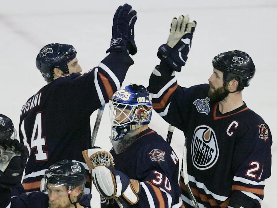 (L-R) Edmonton Oilers Fernando Pisani, Jussi Markkanen and Jason Smith celebrate their 4-0 win over the Carolina Hurricanes in game 6 of the Stanley Cup Finals at Rexall Place in Edmonton, Alta., on Saturday June 17, 2006.