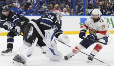 Florida's Jonah Gadjovich (12) strips the puck from Tampa Bay goaltender Andrei Vasilevskiy (88) and defenseman Victor Hedman (77) during the third period of the Lightning's 5-1 win Tuesday night. (AP Photo/Chris O'Meara)