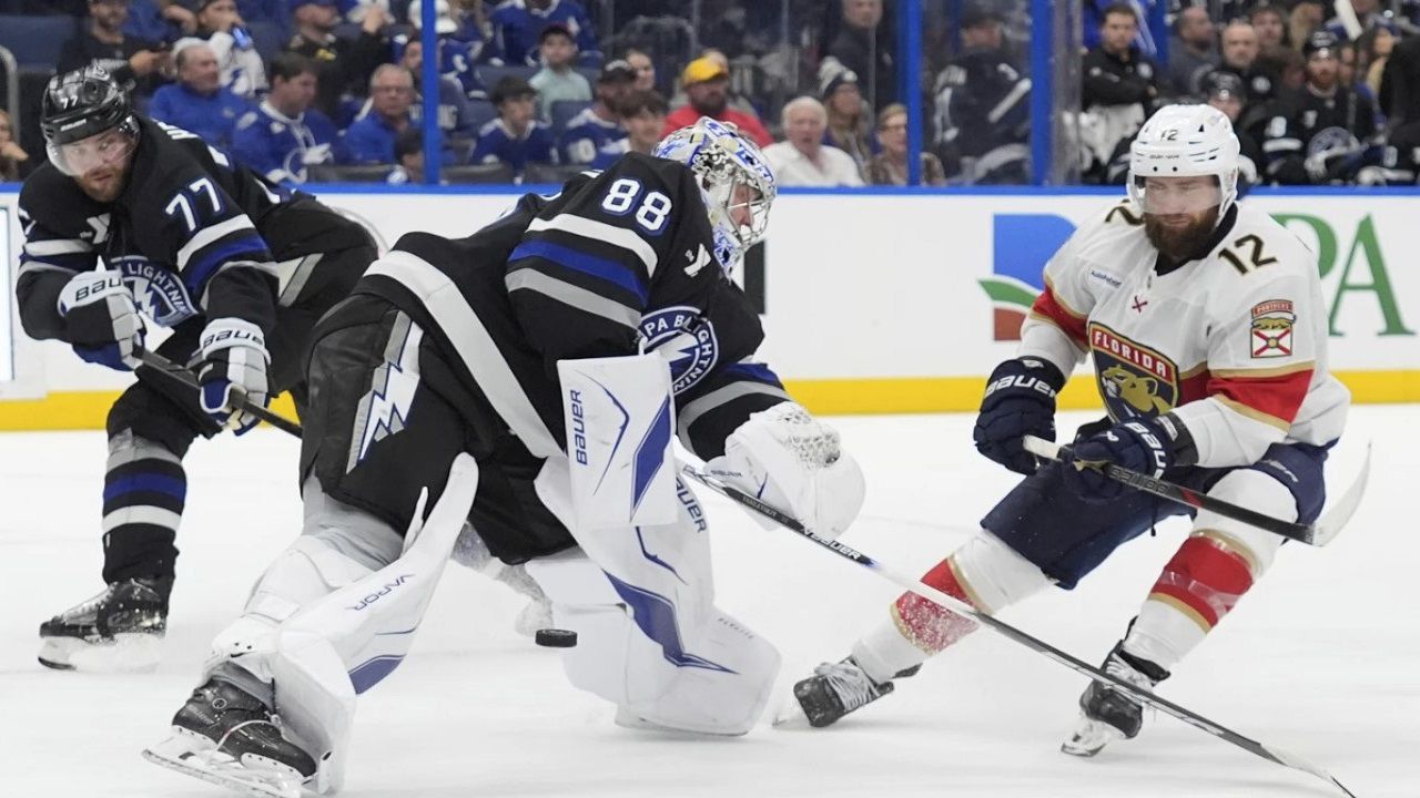 Florida's Jonah Gadjovich (12) strips the puck from Tampa Bay goaltender Andrei Vasilevskiy (88) and defenseman Victor Hedman (77) during the third period of the Lightning's 5-1 win Tuesday night. (AP Photo/Chris O'Meara)