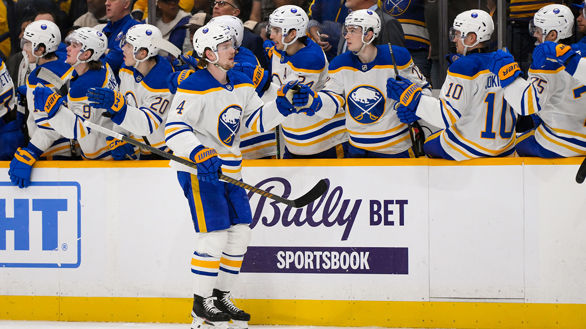 Buffalo Sabres defenseman Bowen Byram (4) celebrates his goal with his teammates against the Nashville Predators during the first period at Bridgestone Arena.