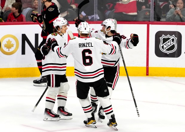 The Blackhawks' Connor Bedard, from left, Sam Rinzel and Frank Nazar celebrate Nazar's game-winning overtime goal against the Senators on April 15, 2025, in Ottawa. (Justin Tang/The Canadian Press via AP)