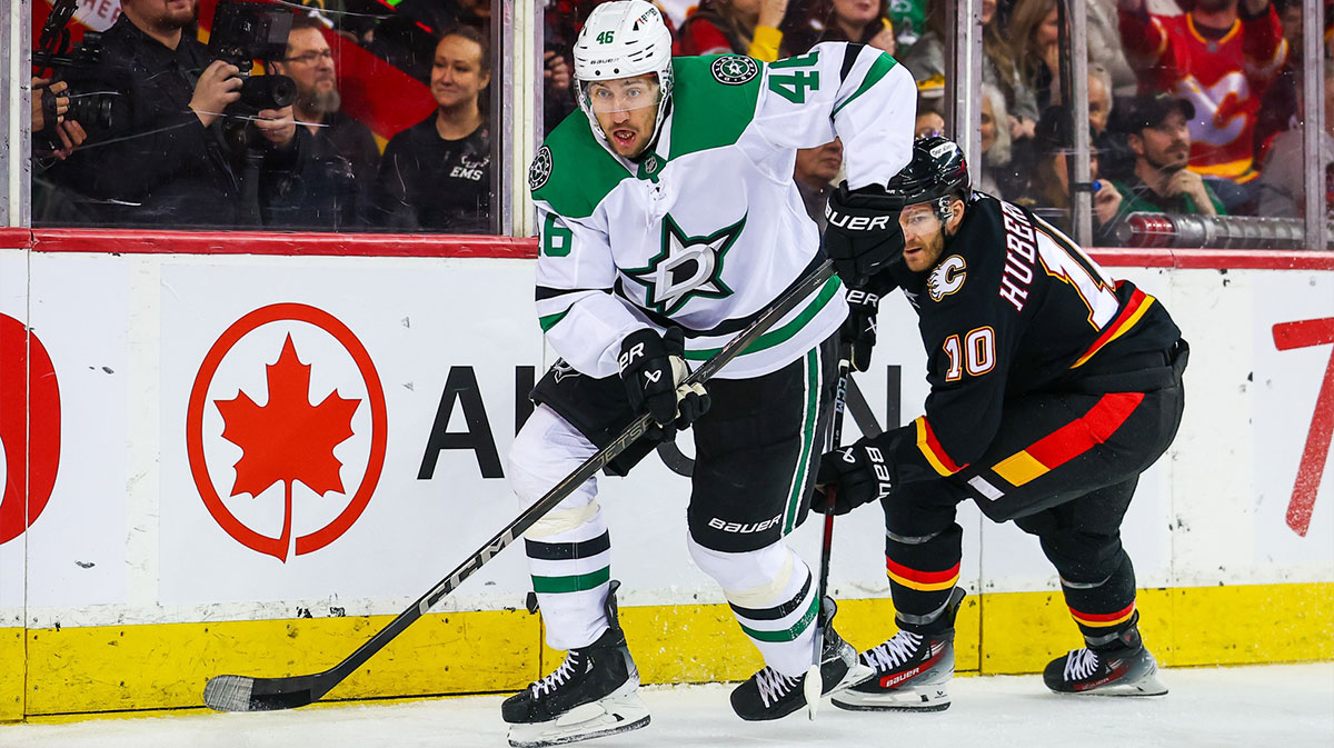 Dallas Stars defenseman Ilya Lyubushkin (46) controls the puck against Calgary Flames left wing Jonathan Huberdeau (10) during the second period at Scotiabank Saddledome.