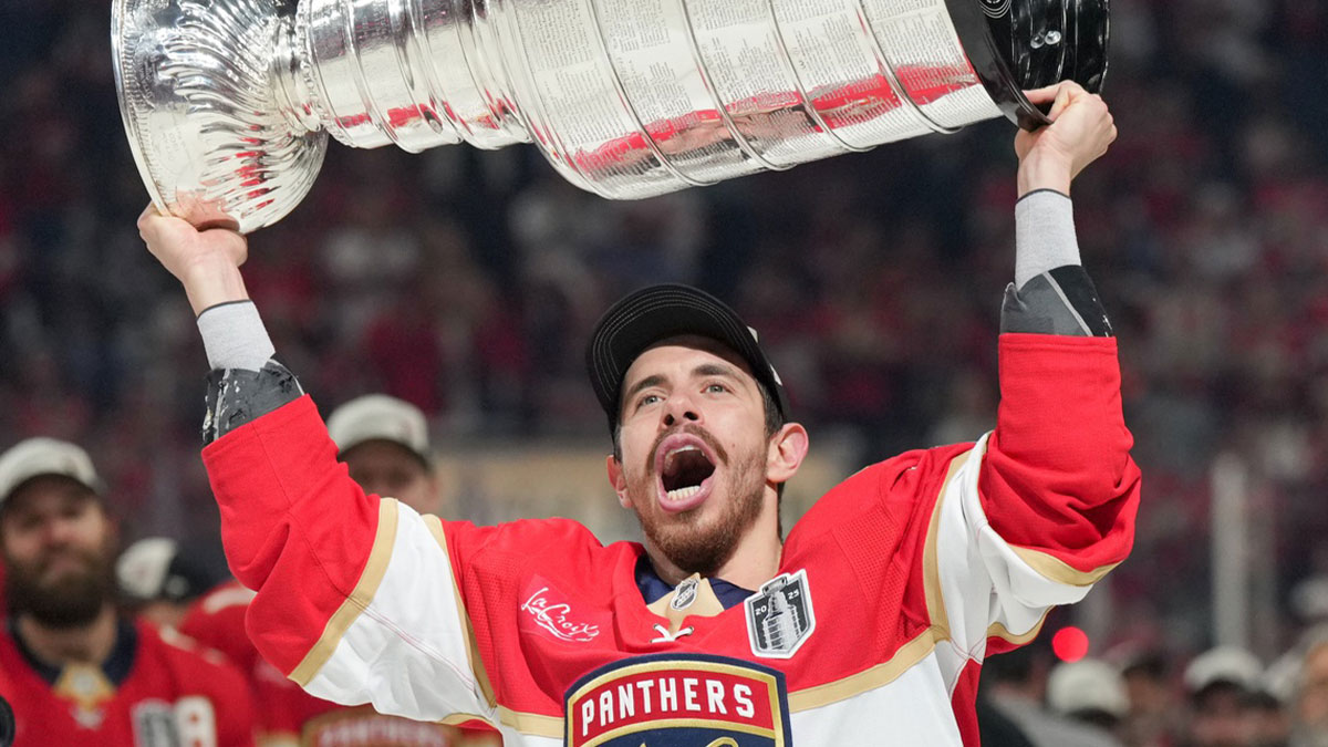 Florida Panthers center Evan Rodrigues (17) hoists the Stanley Cup after winning game six of the 2025 Stanley Cup Final against the Edmonton Oilers at Amerant Bank Arena.