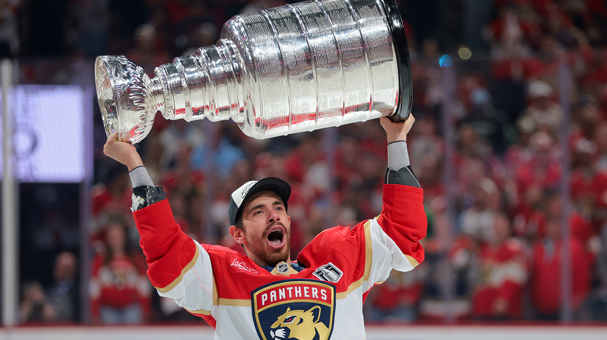 Florida Panthers center Evan Rodrigues (17) hoists the Stanley Cup after winning game six of the 2025 Stanley Cup Final against the Edmonton Oilers at Amerant Bank Arena.