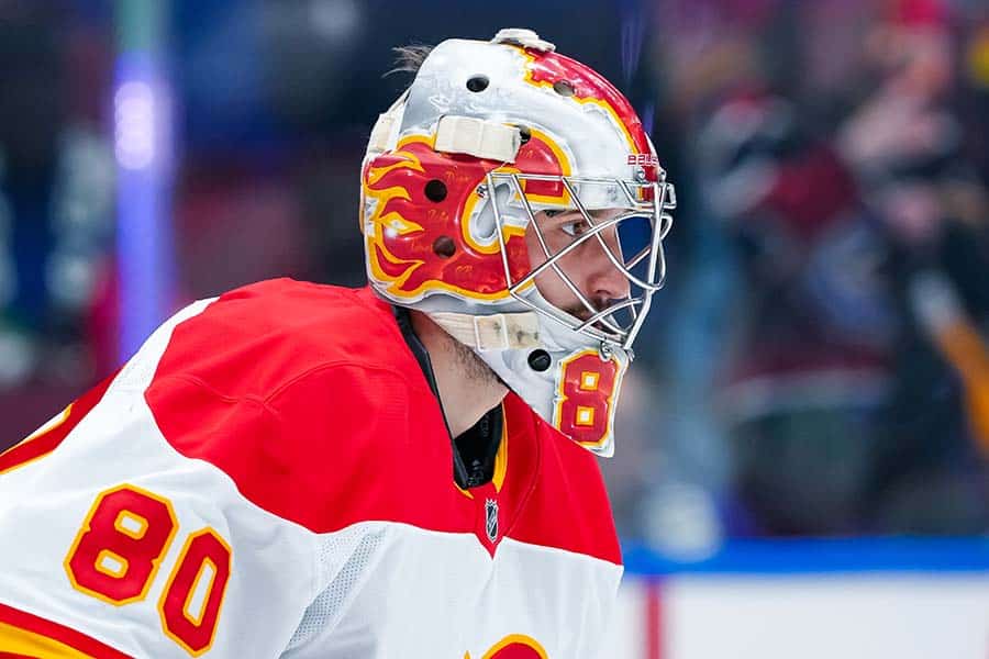 VANCOUVER, CANADA - OCTOBER 9: Dan Vladar #80 of the Calgary Flames in net during warm-up prior to their NHL game against the Vancouver Canucks at Rogers Arena on October 9, 2024 in Vancouver, British Columbia, Canada.