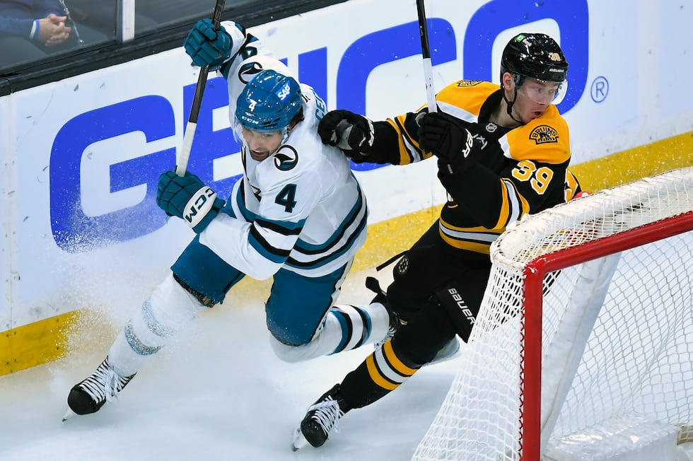 San Jose Sharks defenseman Cody Ceci (4) and Boston Bruins center Morgan Geekie (39) vie for...
