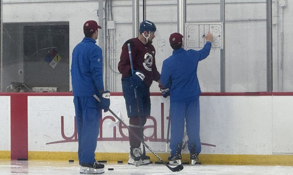 Colorado Avalanche forward Valeri Nichushkin works with skills coach Toby Petersen after the team finished practice and left the ice.