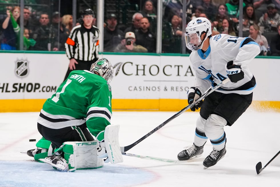 Utah Hockey Club right wing Dylan Guenther, right, attacks against Dallas Stars goaltender...