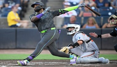 Tampa Bay Rays' Junior Caminero, left, watches the flight of the ball after hitting a three-run home run as Baltimore Orioles catcher Jacob Stallings and home plate umpire Sean Barber, right, look on during the first inning of a baseball game, Friday, July 18, 2025, in Tampa, Fla. (AP Photo/Phelan M. Ebenhack)