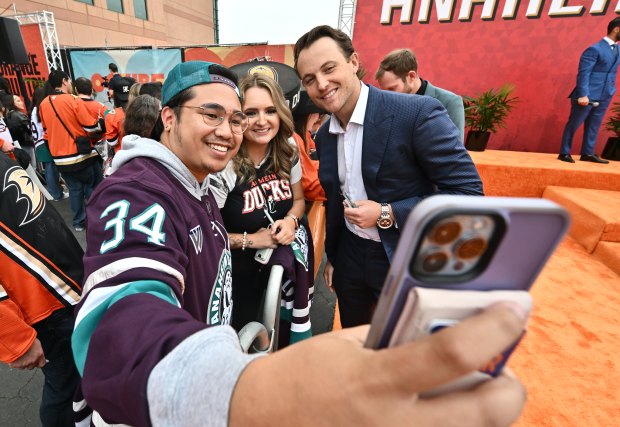 Ducks defenseman Cam Fowler takes a selfie with Josh Biley,...