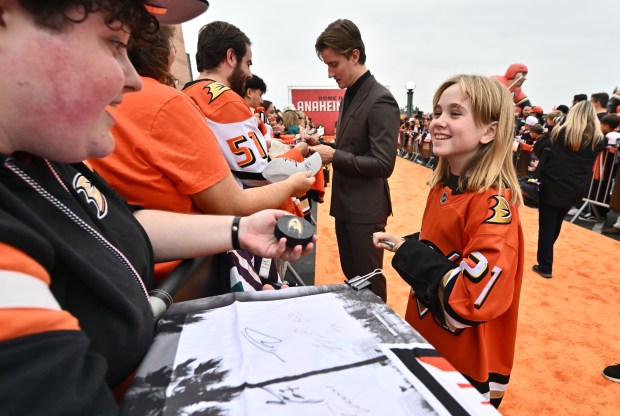 This year’s 21st Duck, 9-year-old Emma Melin of Placentia, signs...