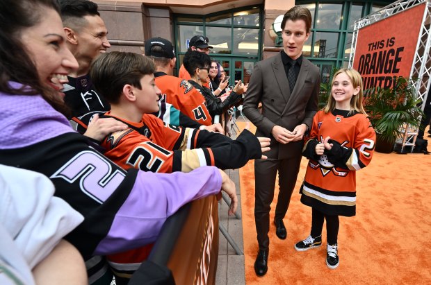 This year’s 21st Duck, 9-year-old Emma Melin of Placentia, signs...