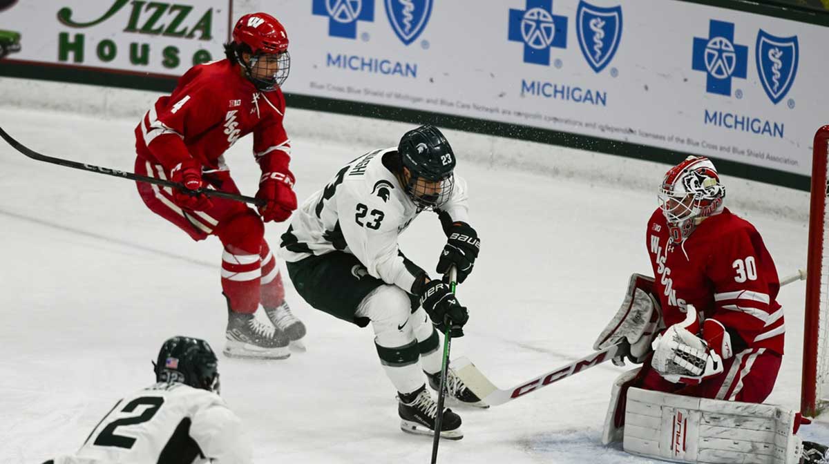 MSU's Shane Vansaghi shoots against Wisconsin goalie Wisconisn goalie Tommy Scarfone, Thursday, Jan. 2, 2024, at Munn Ice Arena. MSU won 4-3.