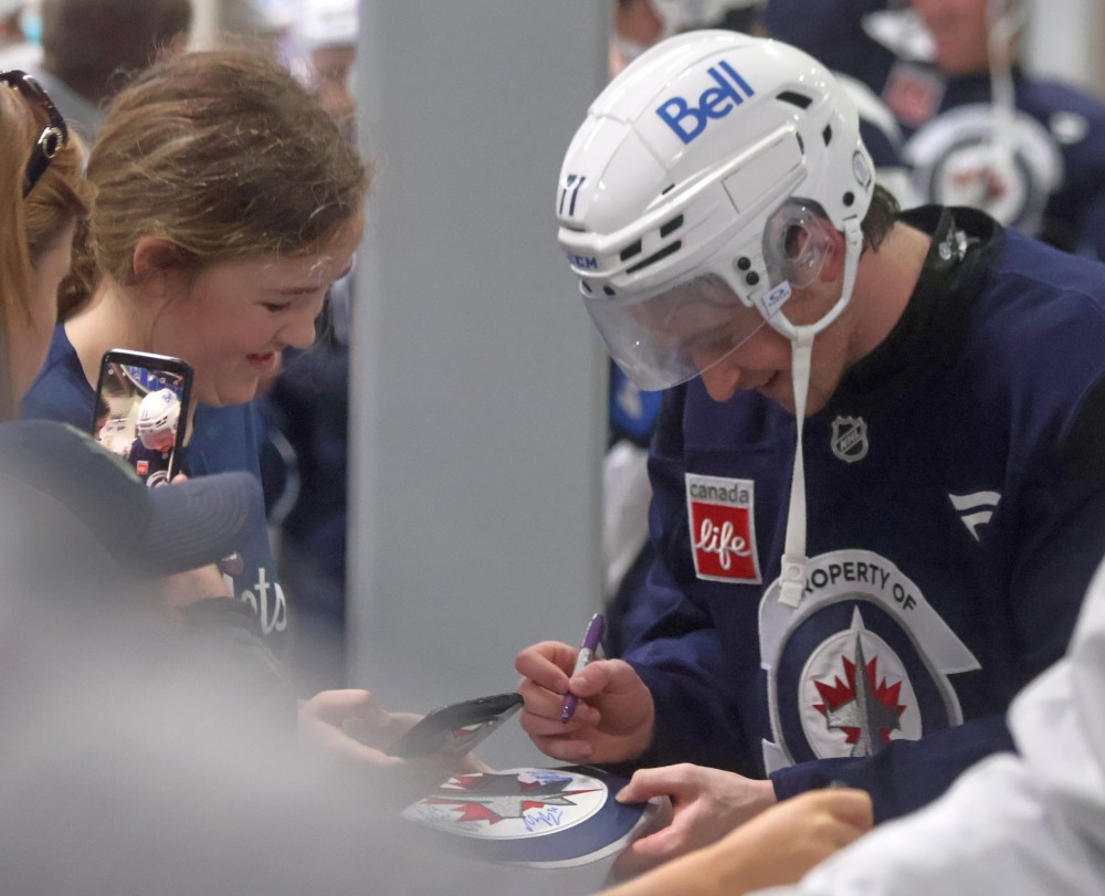 Winnipeg Jets third round draft pick Owen Martin signs autographs for kids after the end of the team's prospect camp. The Oakbank product was on the other side of this interaction not too long ago, and said he was thrilled to be selected by his hometown team at the 2025 NHL draft. (Cassidy Dankochik The Carillon)
