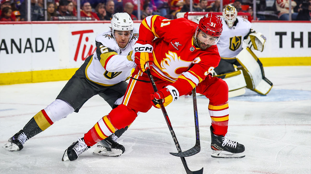 Calgary Flames center Nazem Kadri (91) and Vegas Golden Knights defenseman Zach Whitecloud (2) battles for the puck during the second period at Scotiabank Saddledome.